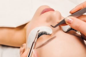 Eyelash Extension Procedure. Woman Eye with Long Eyelashes. Lashes. Close up, macro, selective focus